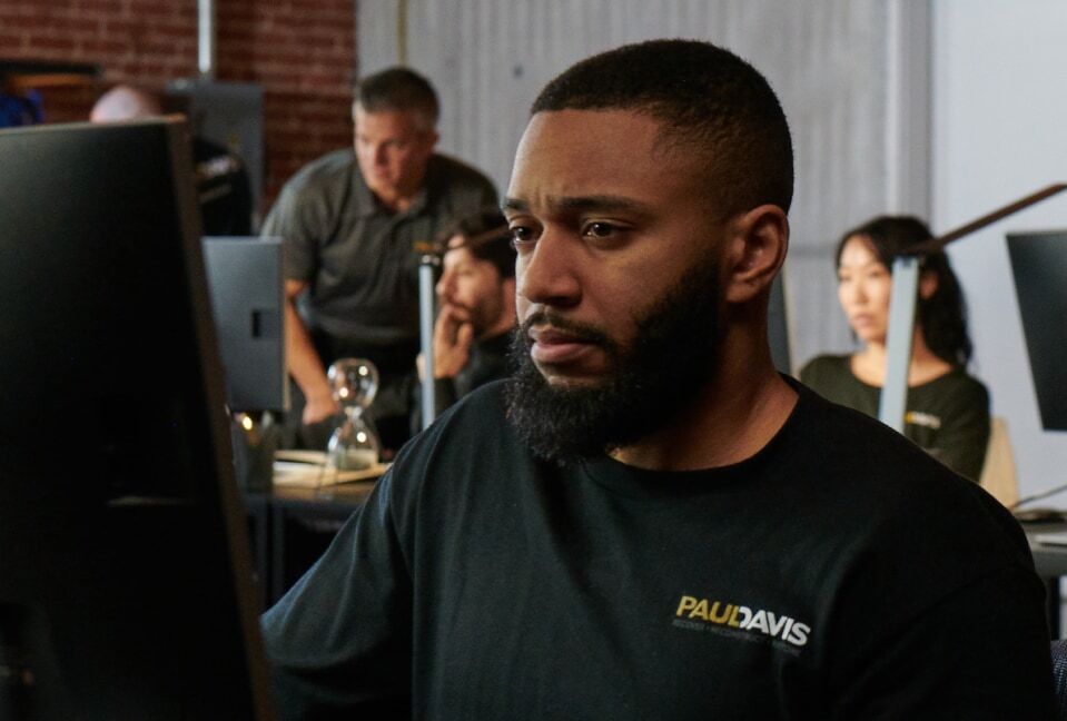 Paul Davis restoration team member working at a computer in the North Atlanta office